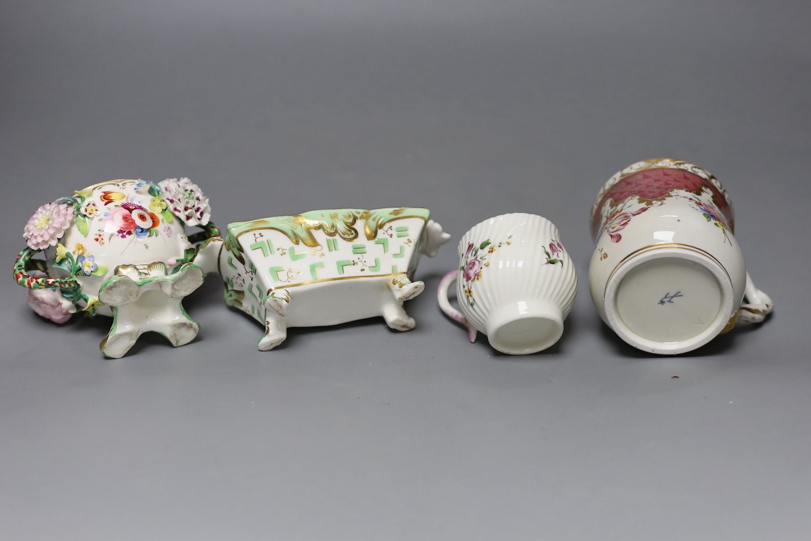 An 18th century Mennecy porcelain cup and cover, a Meissen style cup and cover, an English porcelain floral encrusted double inkwell and cover and a similar jar and cover